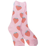 A pair of plush, soft pink crew socks with a repeating all-over pattern of red strawberries.