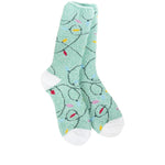 A pair of plush, soft mint green crew socks with a repeating pattern of colorful Christmas string lights.