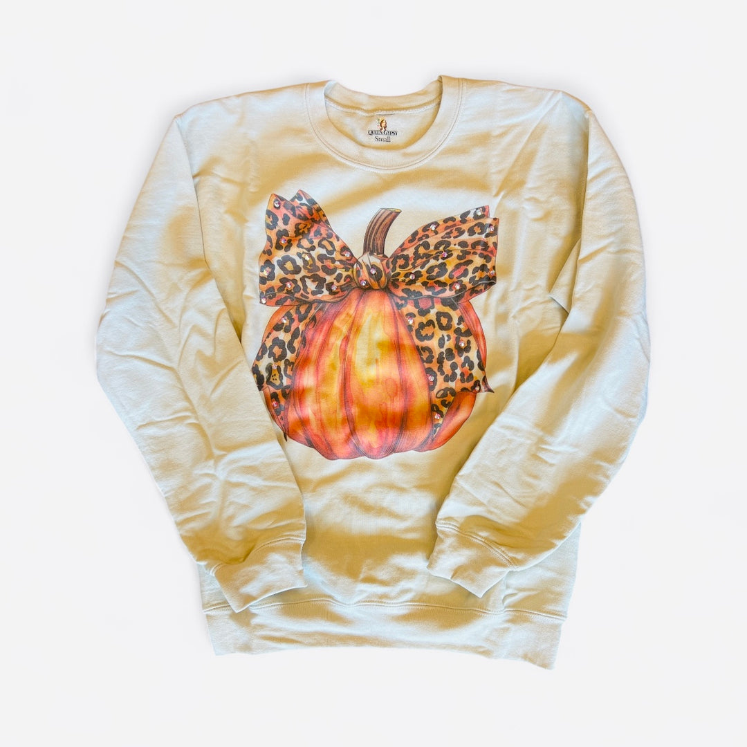 Cream sweatshirt with a fall pumpkin graphic and a leopard print bow.