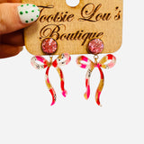 Pink glitter stud earrings with marbled bow in pink, red, white, gold tones