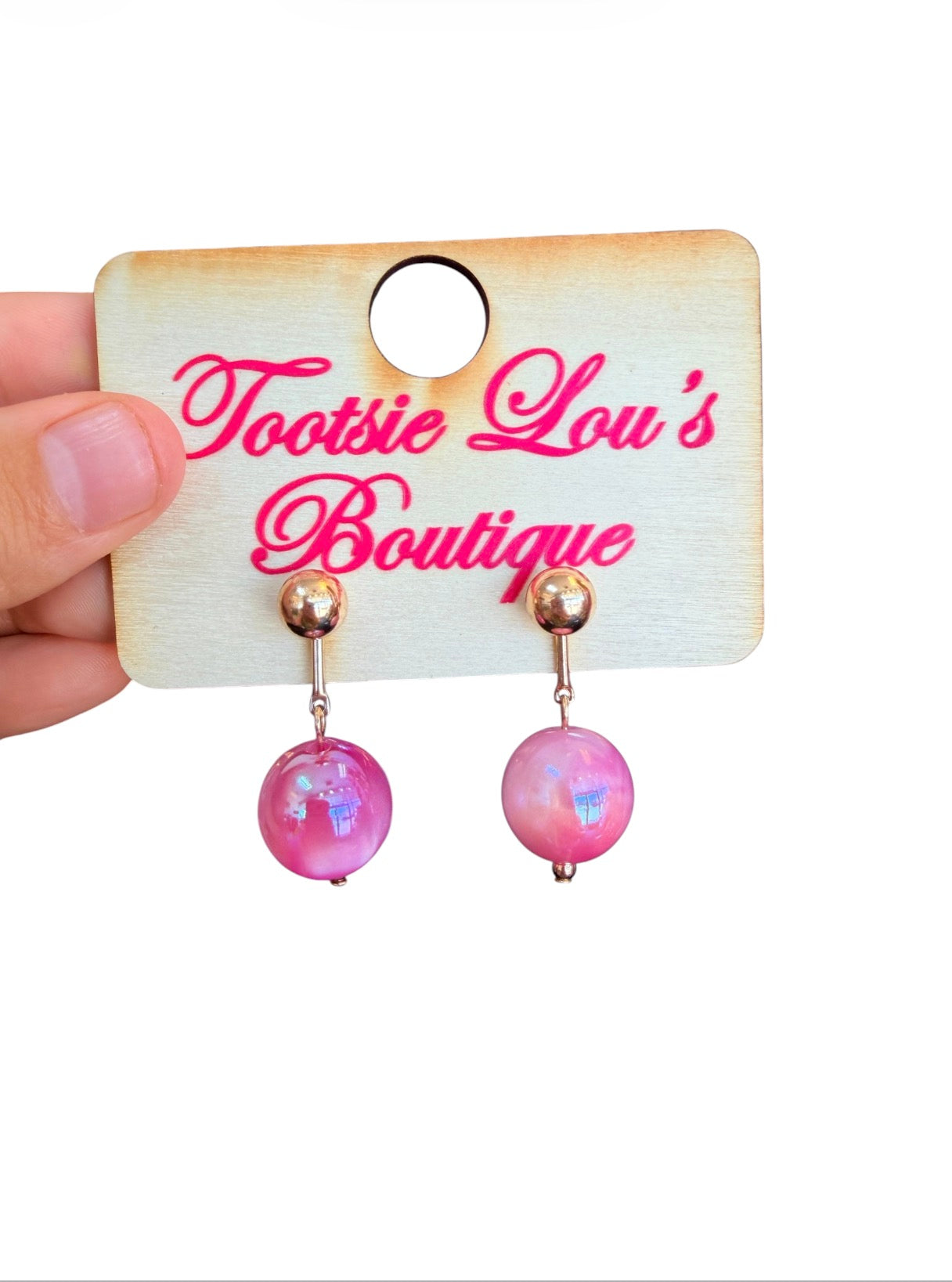 Pink marbled bead stud earrings with glossy finish and gold ball studs.
