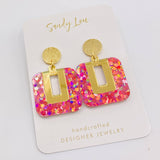 Pink holographic confetti glitter drop earrings with brushed gold studs and gold-plated charm.