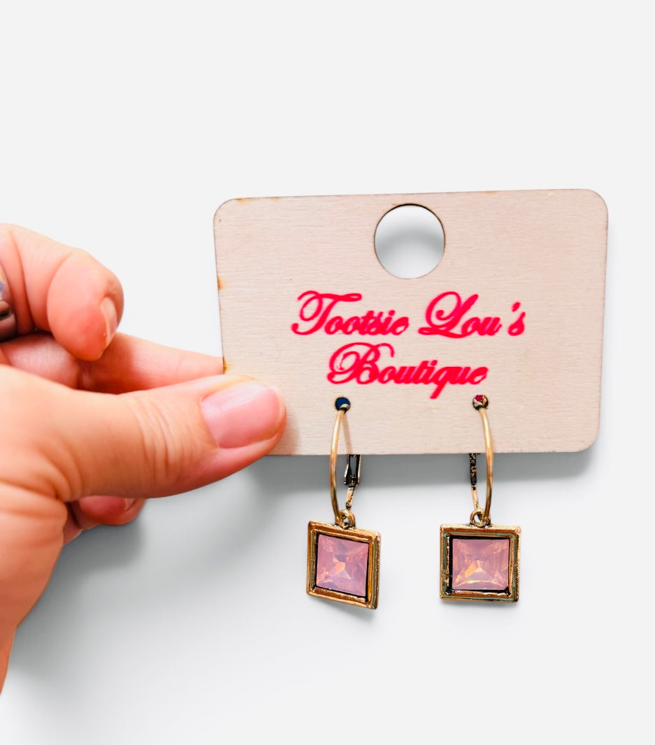 Gold-tone hoops with faceted pink square crystal drop earrings.