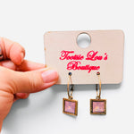 Gold-tone hoops with faceted pink square crystal drop earrings.