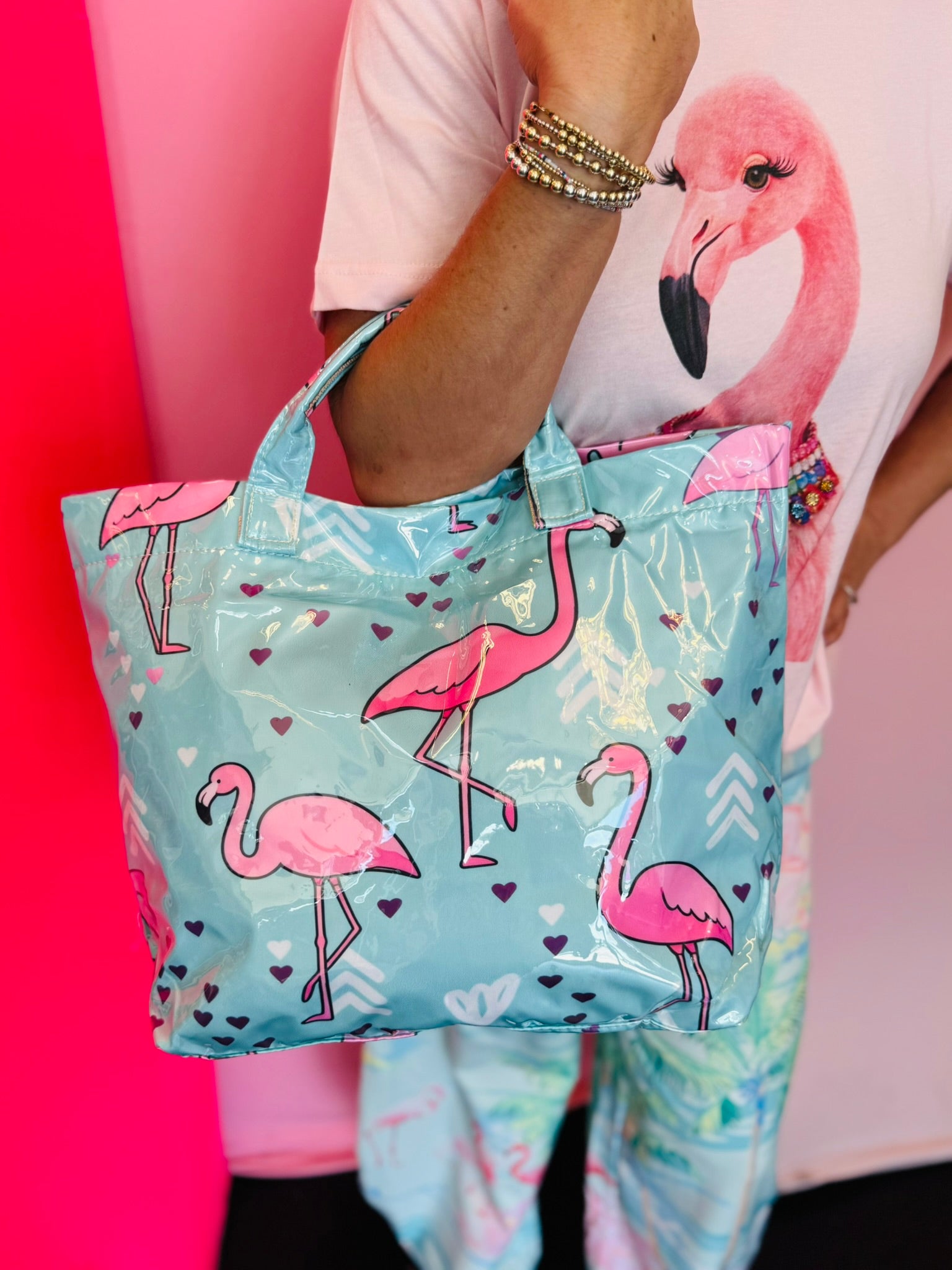 Aqua blue tote bag with pink flamingo print, hearts, and colorful chevron accents
