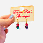 Pink and green gemstone drop earrings with gold hardware and bold color contrast.