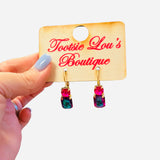 Pink and green gemstone drop earrings with gold hardware and bold color contrast.