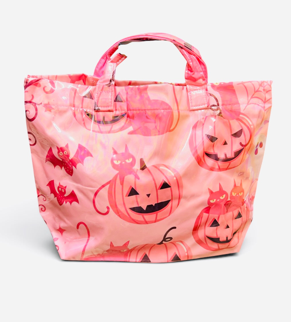 Pink Halloween tote bag with jack-o'-lanterns, black cats, bats, spiderwebs, and coral accents.