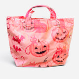 Pink Halloween tote bag with jack-o'-lanterns, black cats, bats, spiderwebs, and coral accents.