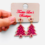 Pink Christmas tree earrings with green crystals, pearl trim, and pearl star studs.