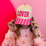 Light pink Lover hat with bold pink lettering and striped pink bill, adjustable snapback closure