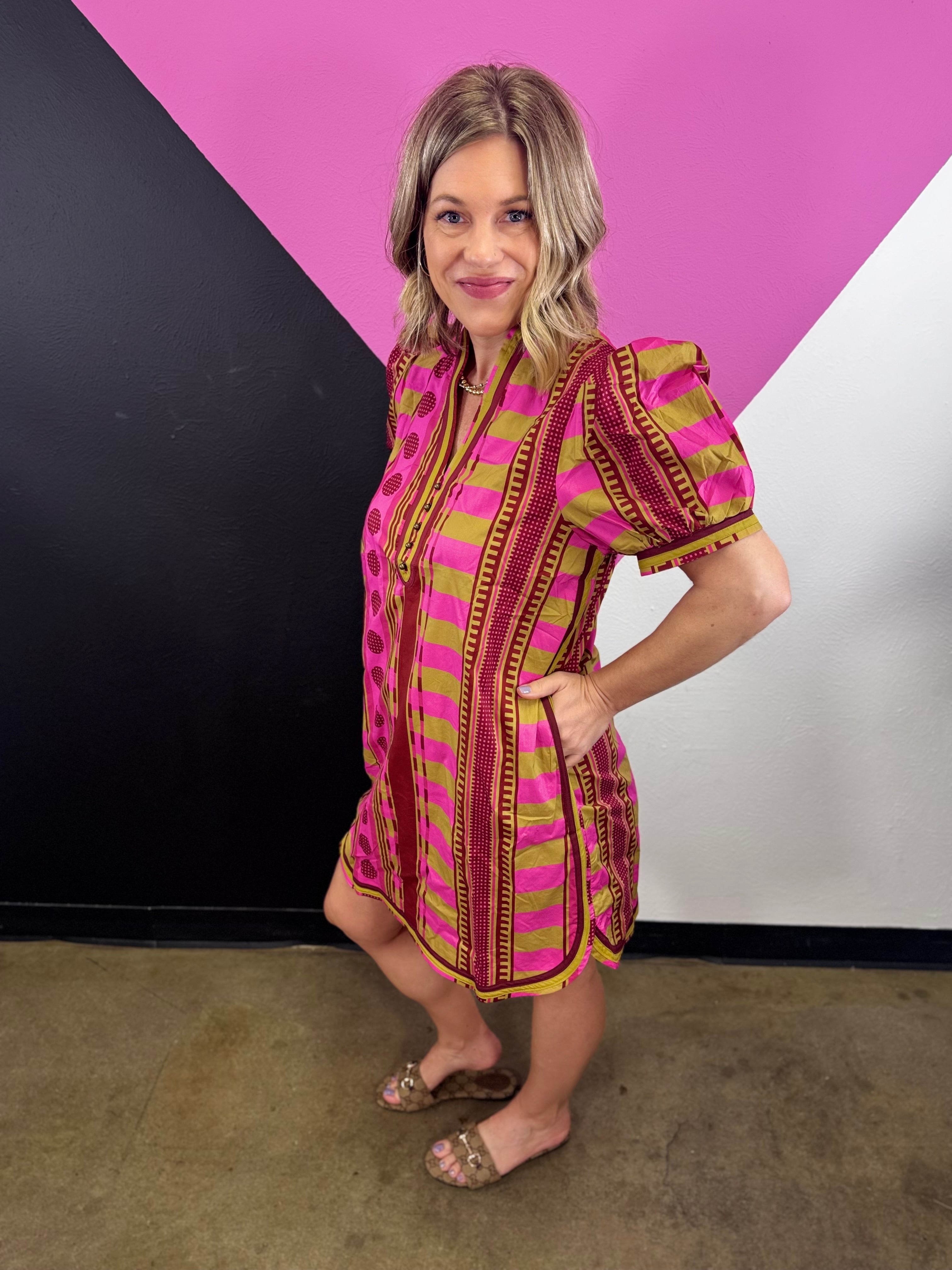 Pink mixed print mini dress with puff sleeves, contrast neckline and colorful geometric patterns.