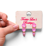 Pink opaque crystal drop earrings with four graduating round stones.