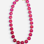 Pink opaque crystal tennis necklace with iridescent stones, gold-tone settings, and magnetic clasp.