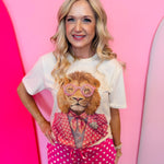 Cream tee with pink polka dot lion graphic and rhinestone accents.