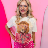 Cream tee with pink polka dot lion graphic and rhinestone accents.