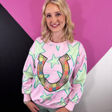 Pink pullover with turquoise stars and colorful patchwork horseshoe graphic.
