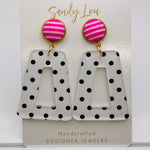 Pink striped stud earrings with black polka dot acrylic drops, lightweight and nickel-free.