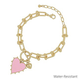Pink studded heart charm bracelet on gold chain, water resistant.