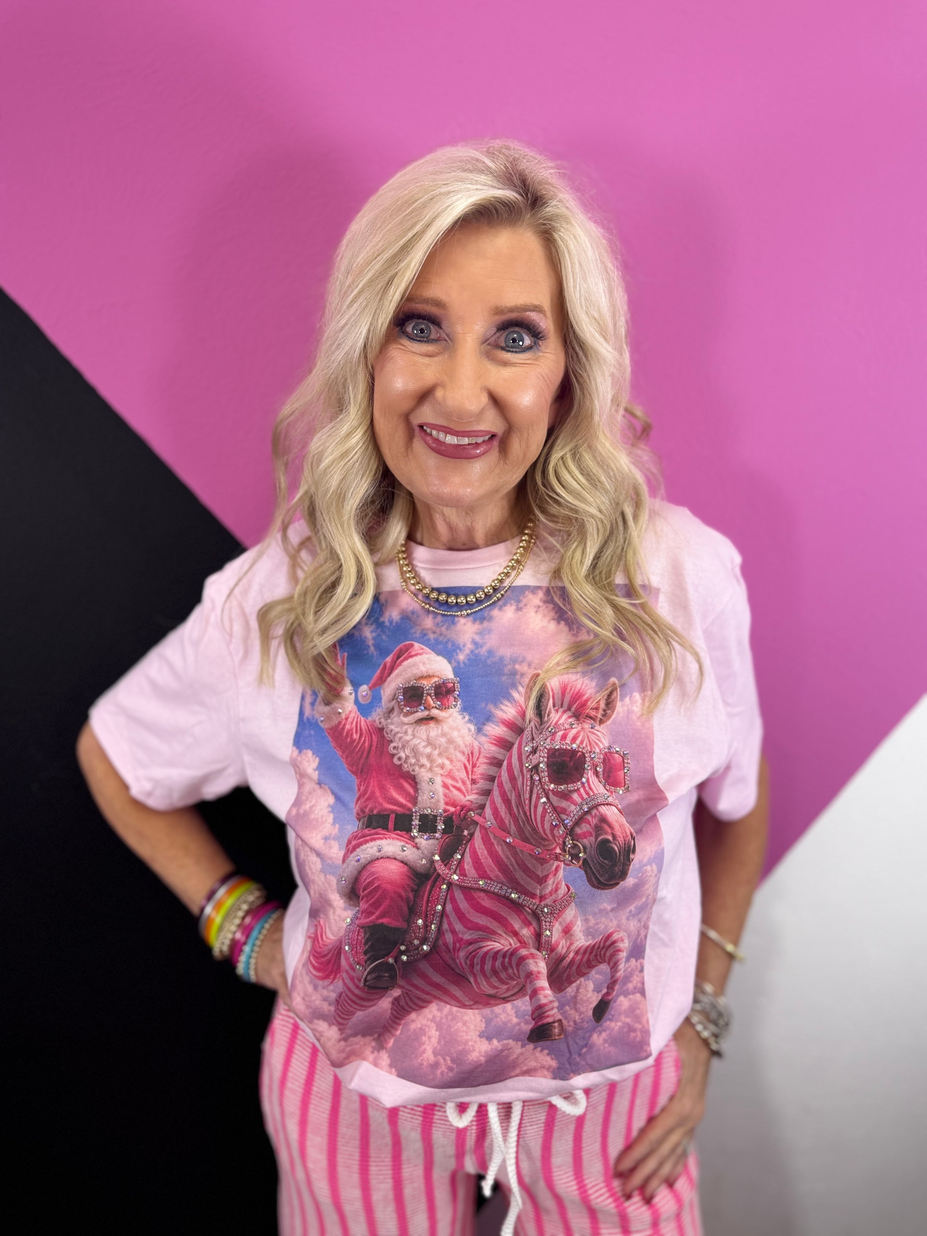 Pink tee with Santa riding a zebra and rhinestones.