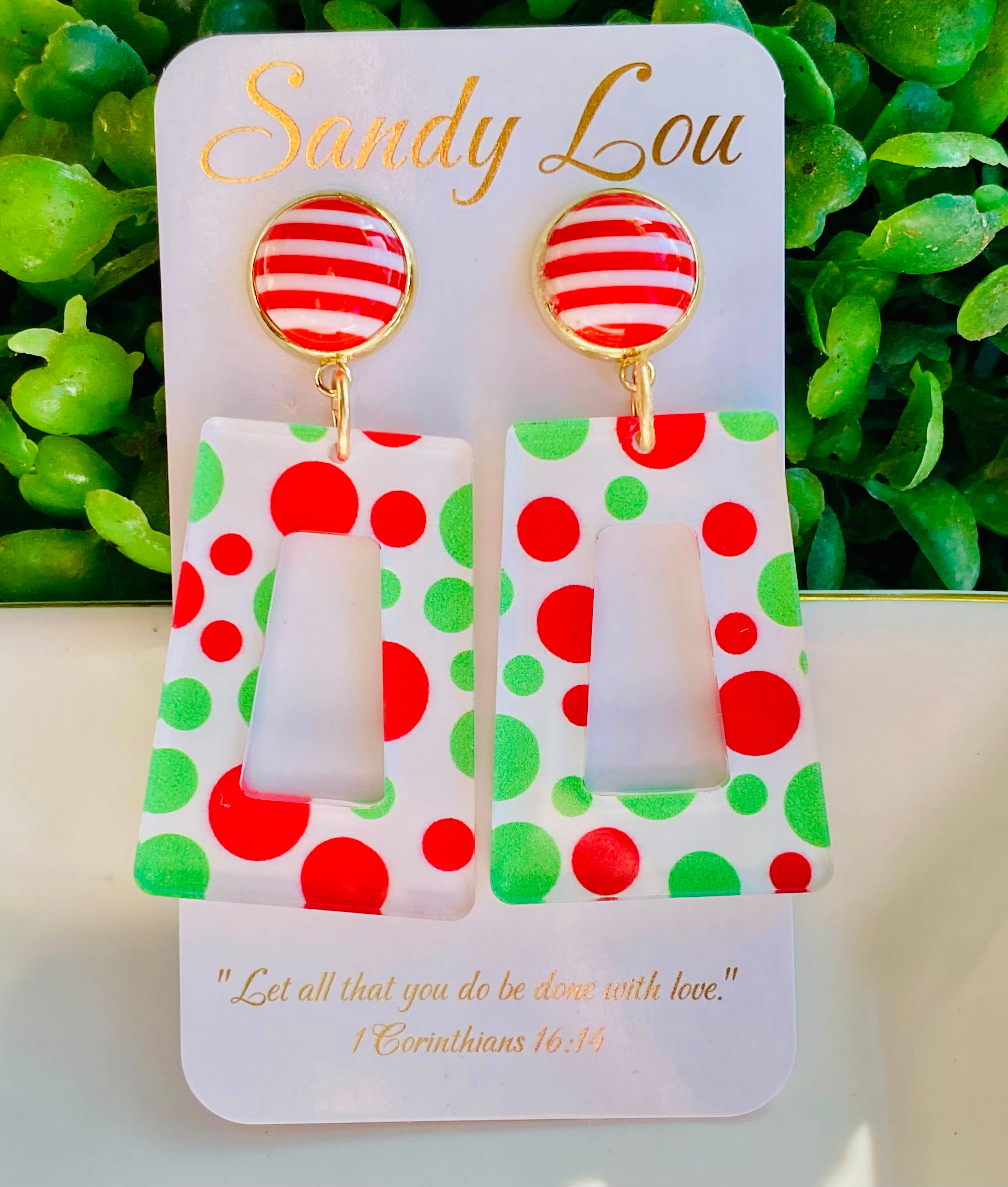 Red and green polka dot Christmas acrylic earrings with striped stud tops.