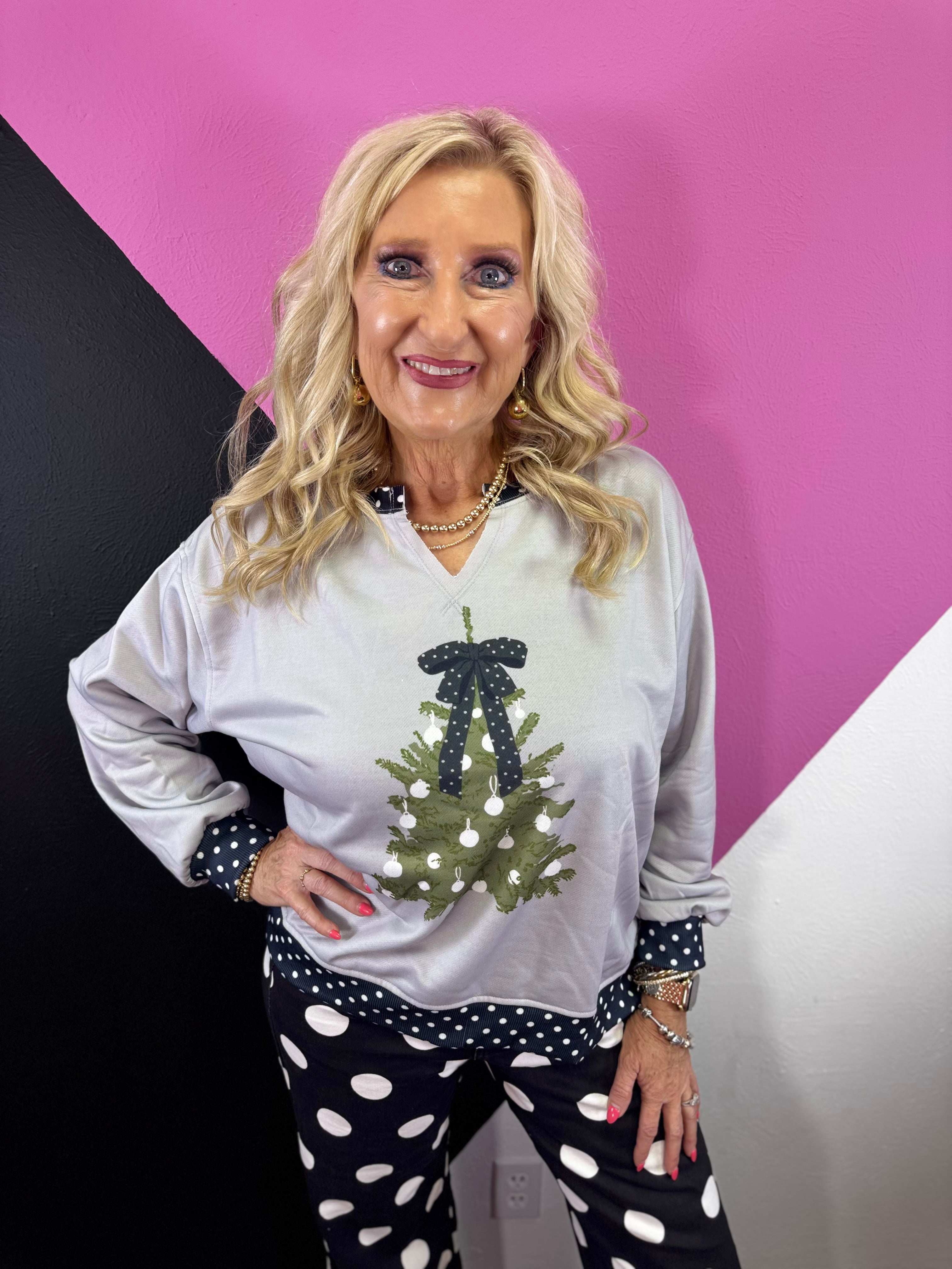 Grey Christmas pullover with green tree, black polka dot bow and matching trim.