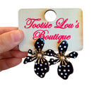 Oversized black floral earrings with white polka dots and gold-tone burst center