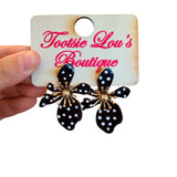 Oversized black floral earrings with white polka dots and gold-tone burst center