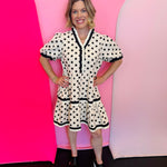 Polka Dot Tiered Dress with puff sleeves, ruffle detail, button front, and flowy tiered silhouette with side pockets.
