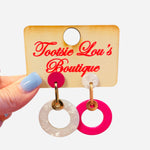 Mismatched pink and pearl double hoop earrings with gold hardware.