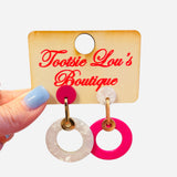 Mismatched pink and pearl double hoop earrings with gold hardware.