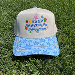 Off-white hat with lucky stars embroidery, strawberry accents, and blue star-print bill.