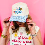 Off-white hat with lucky stars embroidery, strawberry accents, and blue star-print bill.