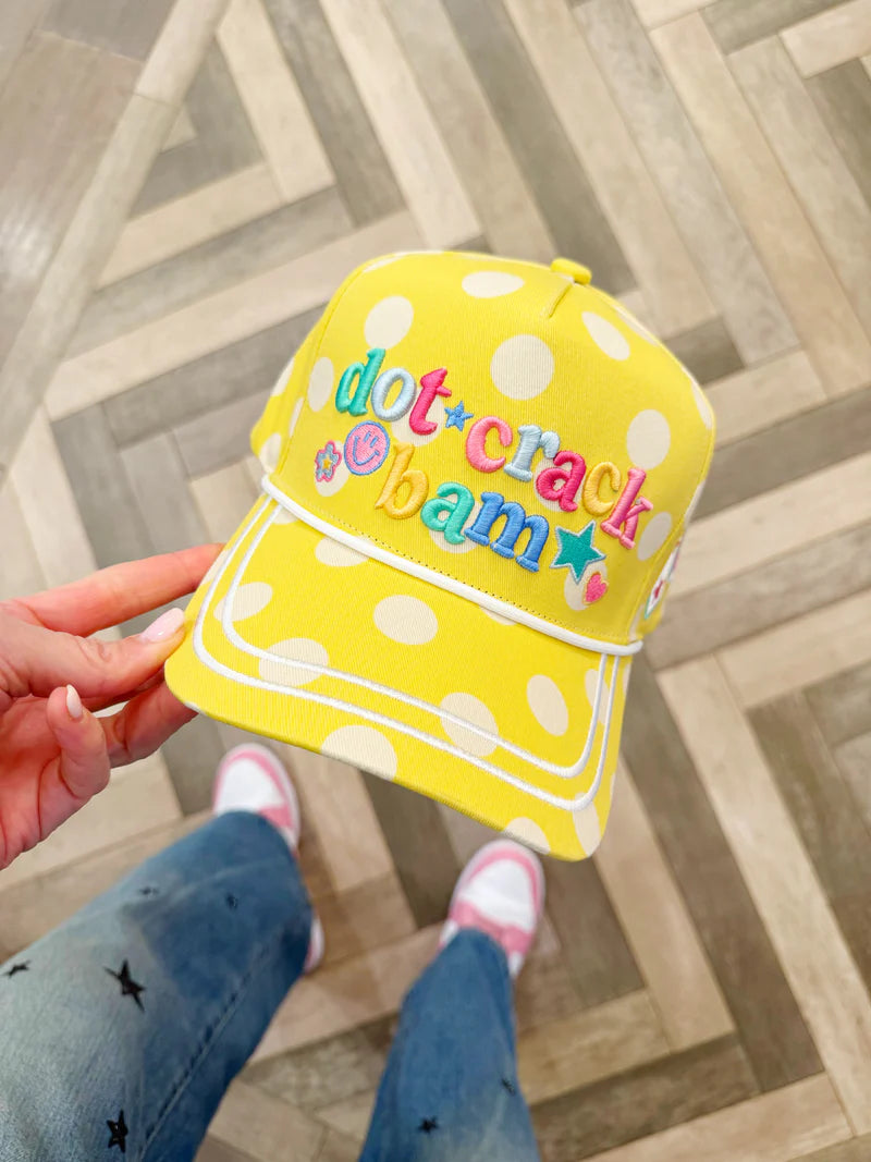 Yellow polka dot hat with smiley face, stars, flowers, and pickleball-themed embroidery.
