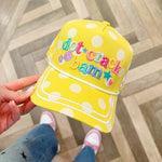 Yellow polka dot hat with smiley face, stars, flowers, and pickleball-themed embroidery.