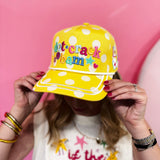 Yellow polka dot hat with smiley face, stars, flowers, and pickleball-themed embroidery.