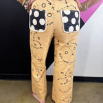 Tan denim jeans with brown football playbook sketches, X’s, O’s, and arrows.