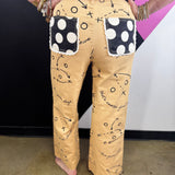Tan denim jeans with brown football playbook sketches, X’s, O’s, and arrows.