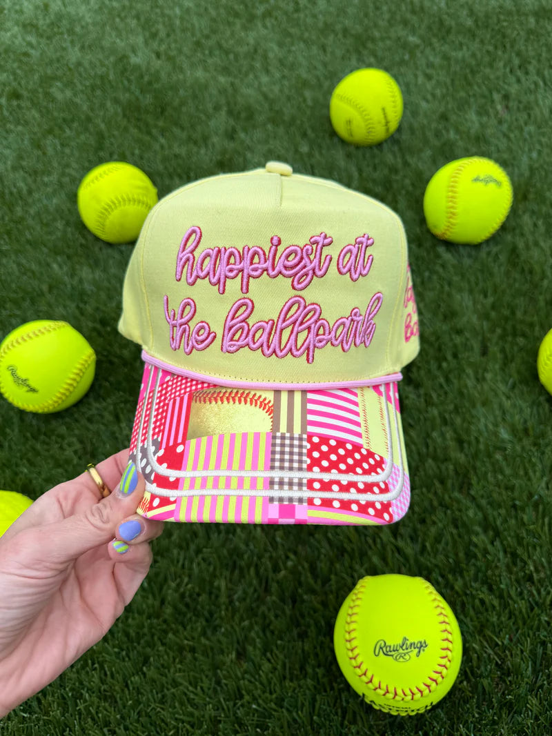 Yellow ballpark hat with pink embroidery, softball details, hearts, and playful designs.