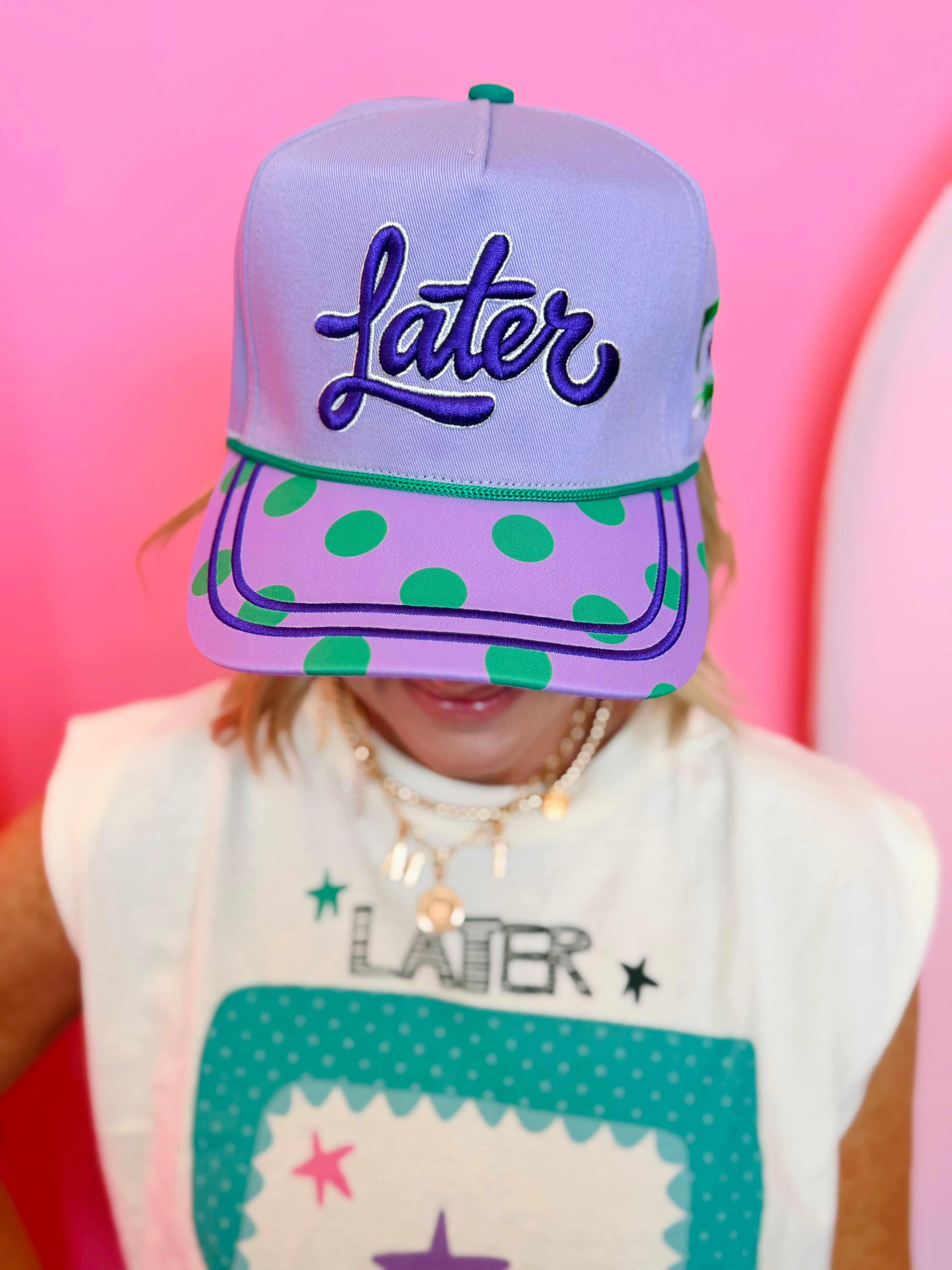 Lavender hat with green polka dot brim, alligator graphic, and “Later” embroidery.