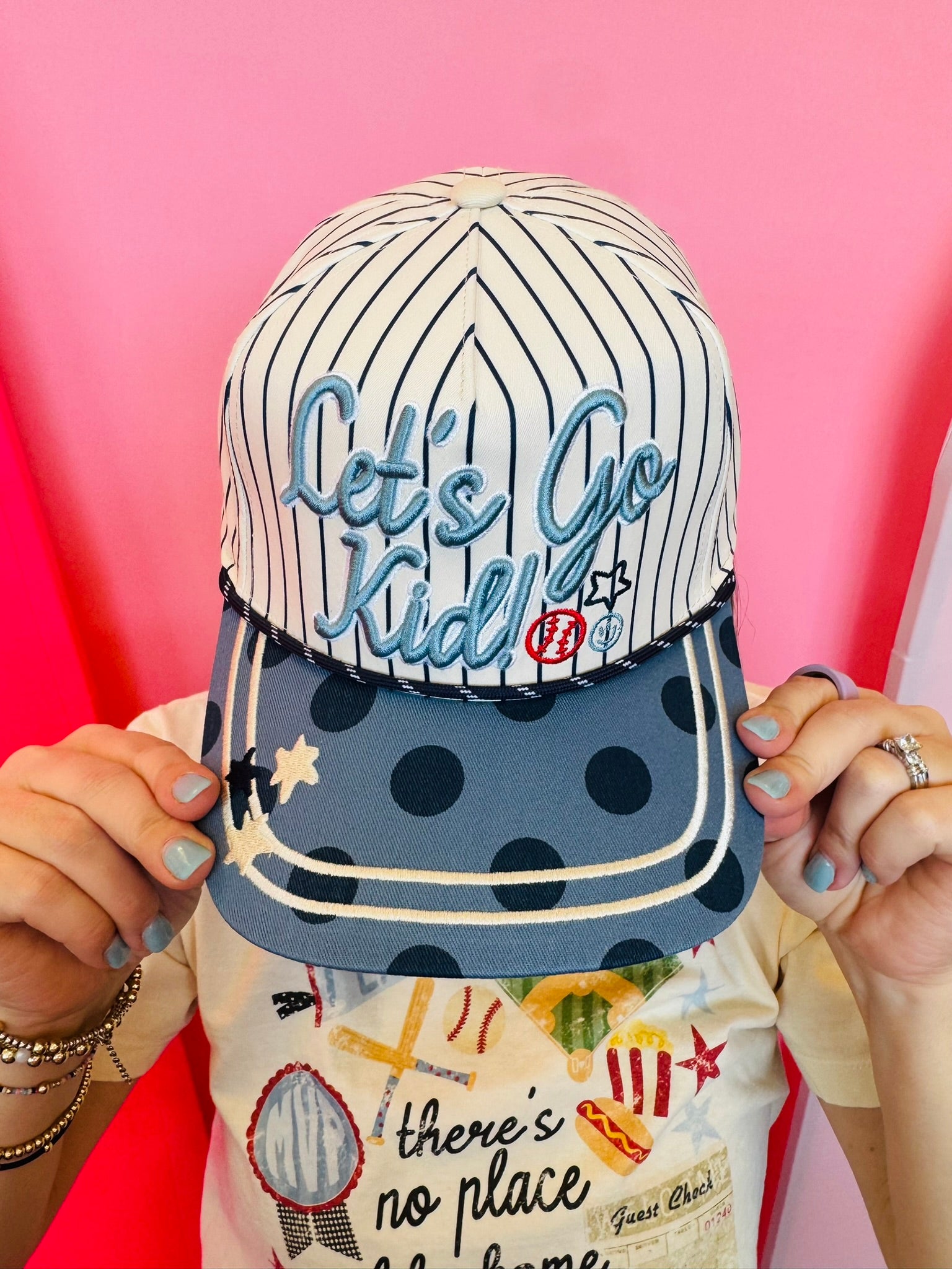 Pinstripe baseball hat with Let’s Go Kid embroidery and blue polka dot brim