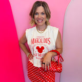 Cream muscle tank with red magical theme park graphic and relaxed fit.