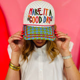 White hat with rainbow Make It a Good Day embroidery and colorful patterned bill.