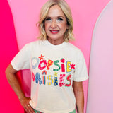Ivory cropped graphic tee with colorful Oopsie Daisies lettering and retro floral design