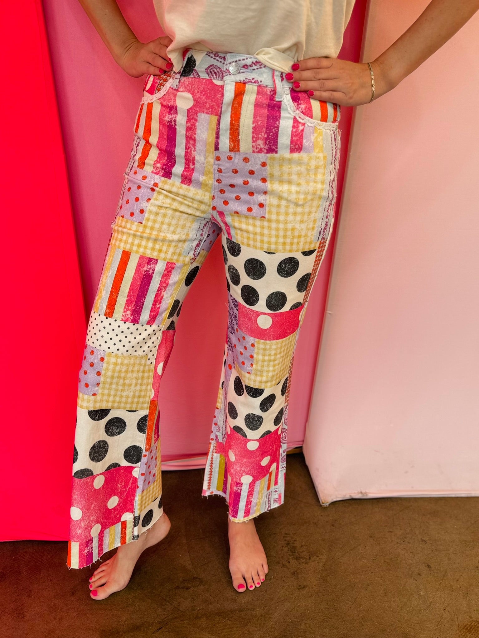 Wide leg patchwork jeans with pink prints, polka dots, stripes, and lace pockets.