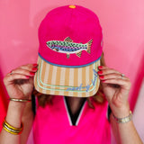 Pink faux suede hat with fish embroidery, striped bill, and Reel-y Busy detail.