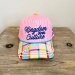 Pink striped faith hat with “Kingdom Over Culture” embroidery, pastel patchwork brim, adjustable snapback.