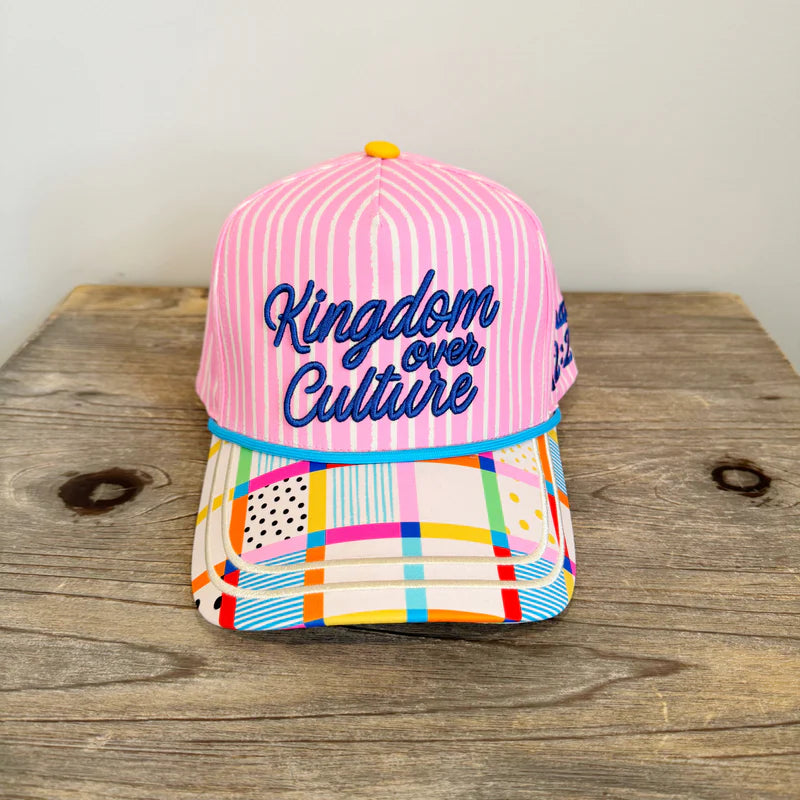 Pink striped faith hat with “Kingdom Over Culture” embroidery, pastel patchwork brim, adjustable snapback.