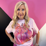 Pink tee with colorful pumpkin, oversized bow, and rhinestone accents.