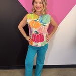 Cream sleeveless sweater with colorful watercolor pumpkin print and rounded neckline